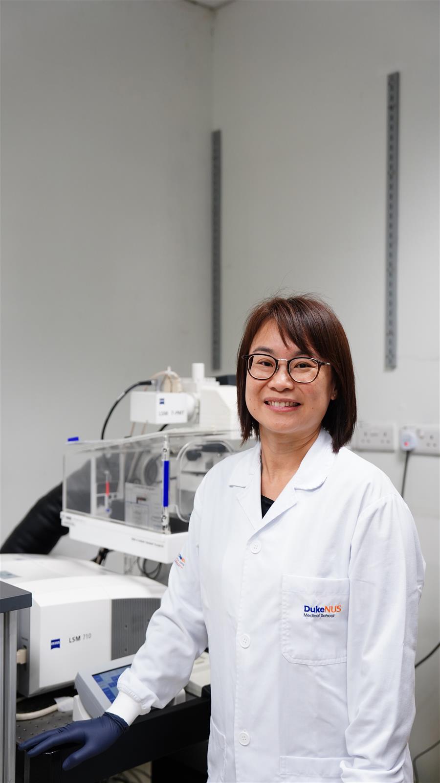 Tay with the confocal microscopes she often uses in her work for HG Vision Lab. // Credit: Norfaezah Abdullah, Duke-NUS