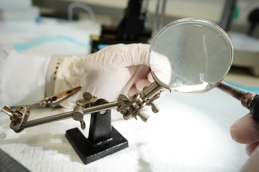 A close up of an EEG electrode being worked on