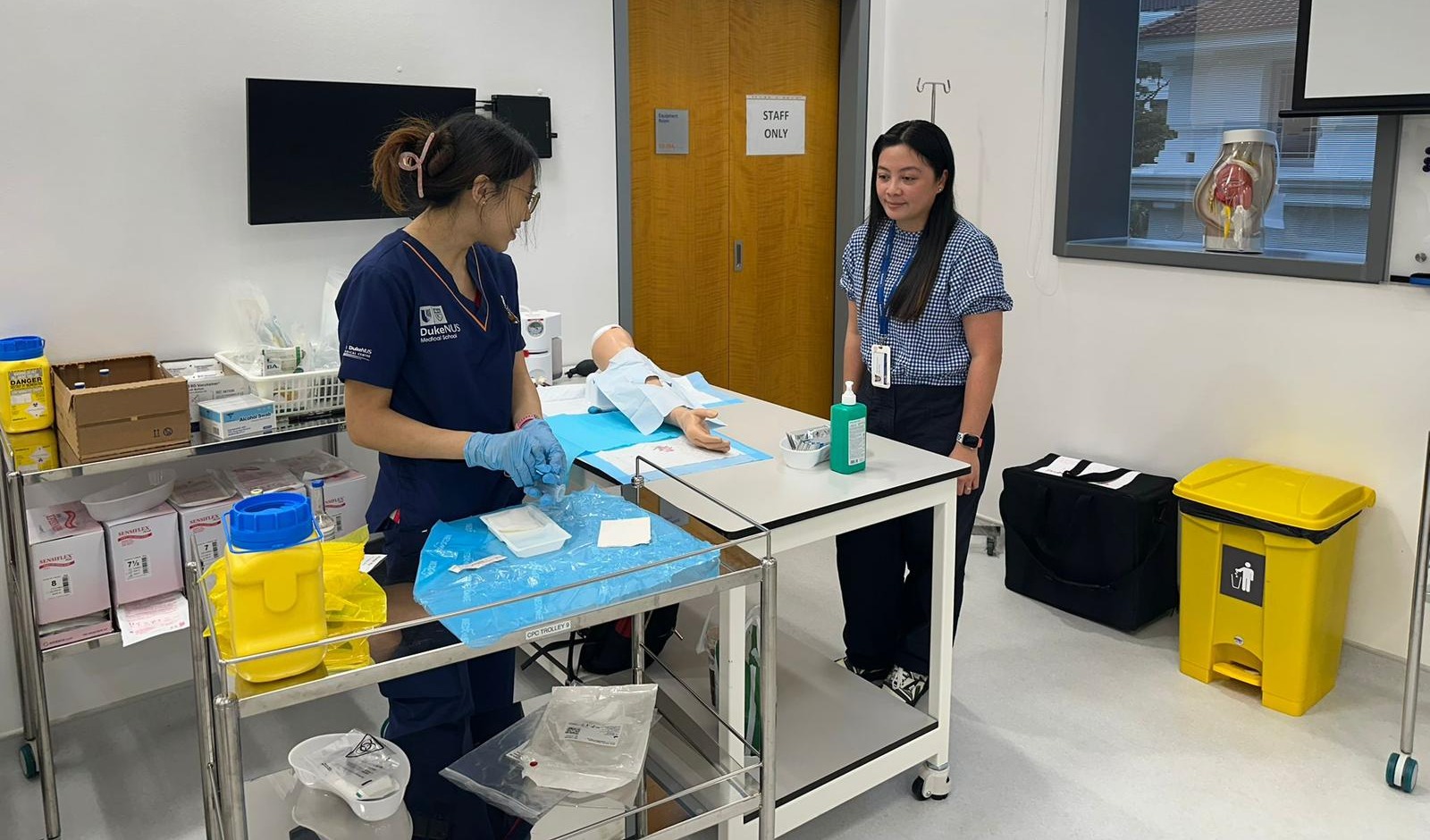 Legaspi-Pelayo observes a Year 2 student inside the Procedural Skills Learning Lab performing an aseptic blood culture collection procedure.