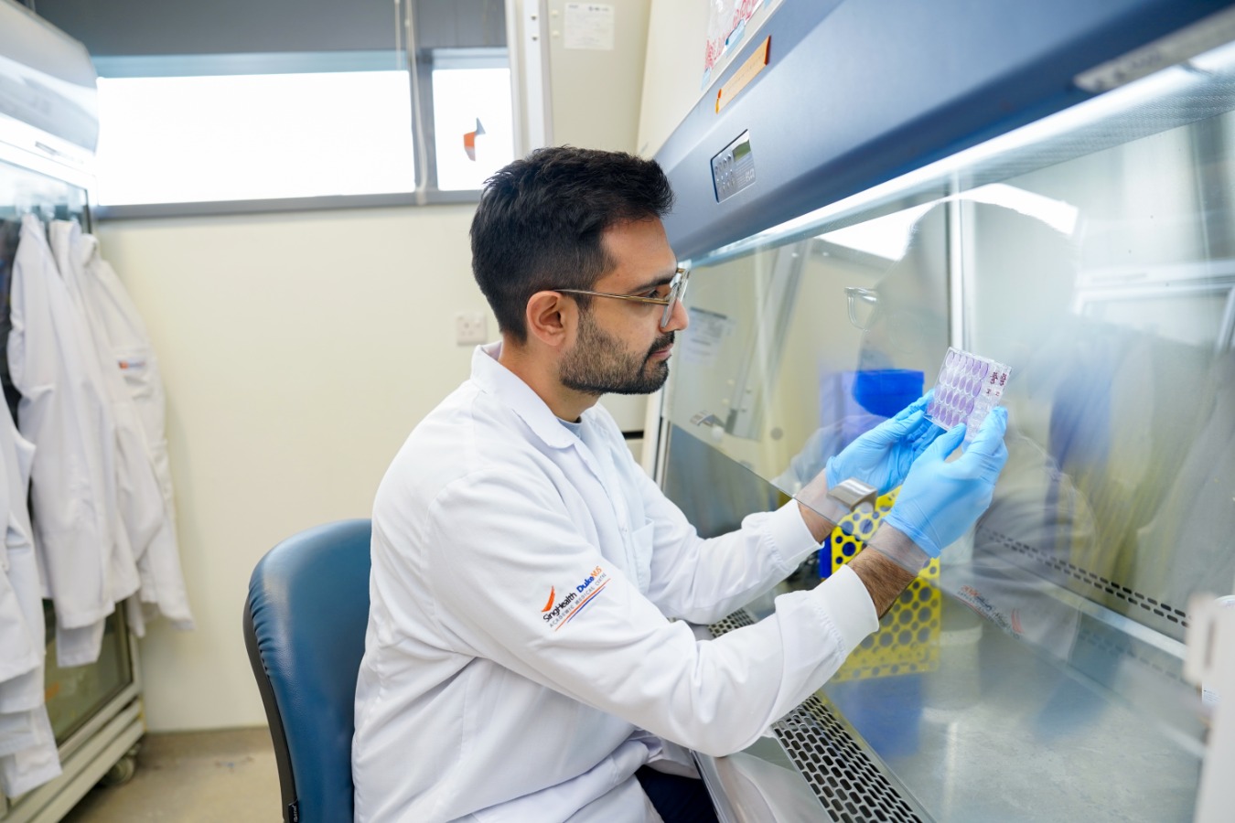 Study team researcher reviewing patient immune test results.
